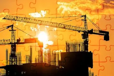 Tower cranes and building silhouettes at  sunrise jigsaw puzzle