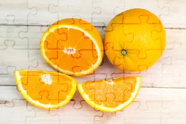 Composition of fresh ripe cut oranges on wooden ba jigsaw puzzle