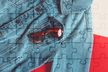 Sunglasses in a jeans jacket pocket on a colored b jigsaw puzzle