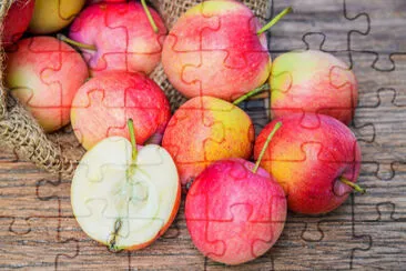 Fresh apples with a cloth sack bag on wood table jigsaw puzzle