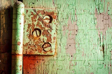 Old rusty hinge with bolts in it. Grungy green pai jigsaw puzzle