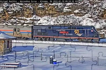 פאזל של Amtrak engine #-100 leading train #-42 around Horseshoe Curve,PA/USA