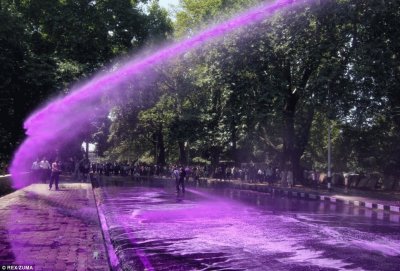 Protesters Shot with Purple Water Cannon-India