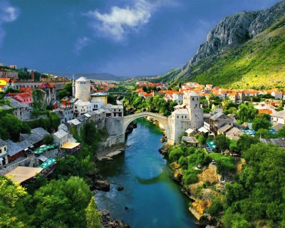 alpine_town_mountains_houses_bridge_