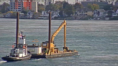 tug Capt Keith pushing a Spud-Barge with excavator